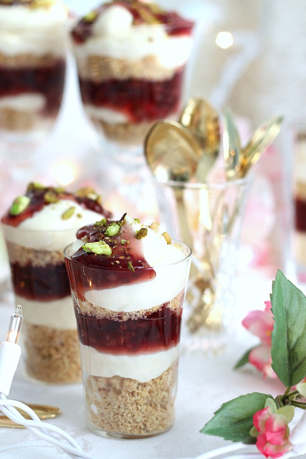 Easy No-Bake Raspberry and Pistachio Cheesecake Parfaits are so pretty and taste delicious. Make tiny, shot-size or fill you fanciest glasses. Change the fruit pie filling or use fresh fruit. It is up to you and it is all good!