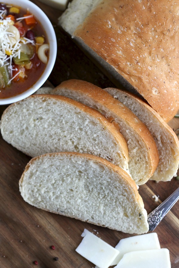 Cracked Pepper, Parmesan and Herbed Bread is full of flavor, slices beautifully and great for sandwiches or buttered and serves with soup or salad. Easy recipe dough is made in a bread maker and shaped as desired. Allow to rise, bake and enjoy!