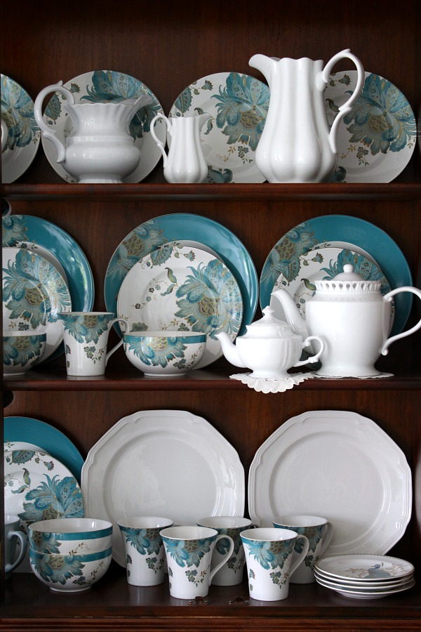 Dining room china cabinet with teal dinnerware dishes from 222 Fifth aqua and teal peacock pattern.
