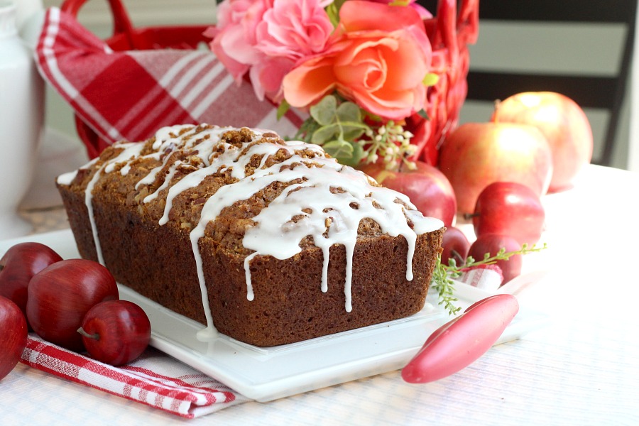 Easy recipe for frosted applesauce bread full of warm flavors of cinnamon, allspice & nutmeg. You don't even need a mixer to make this delicious quick bread.