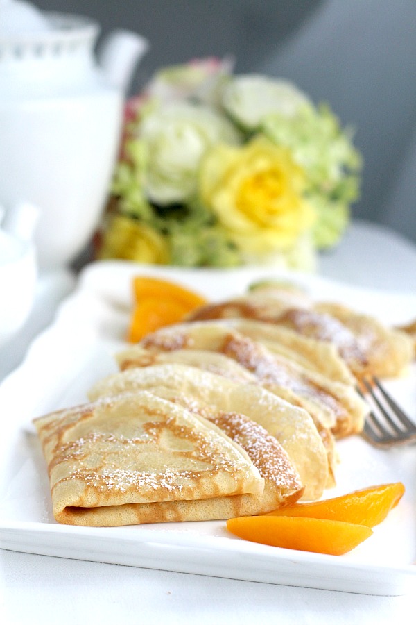 Peaches and Cream Cheese Crepes begins with a simple crepe, then filled with a sweetened cream cheese mixture, fresh sliced peaches, a sprinkling of brown sugar and a pat of butter that is then baked until warmed through. A dusting of confectioners' sugar and topped with whipped cream finishes this lovely dessert.