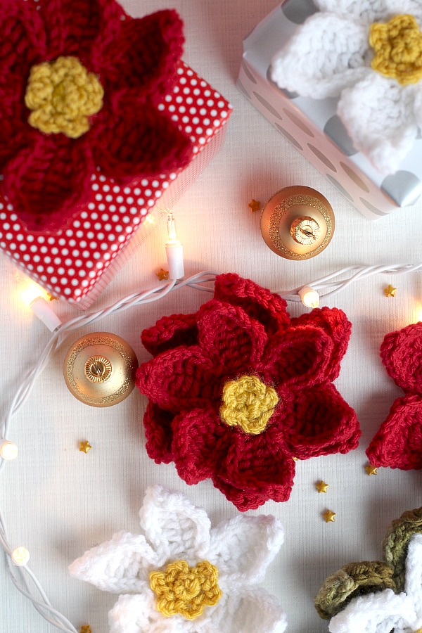 Decorate gifts, wreaths, sew to hats, pillows, or hang as ornaments pretty crochet poinsettia flowers. Festive for holiday decorating and quick and easy to make.