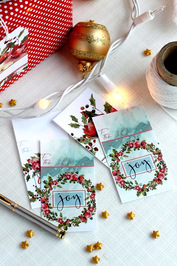 Pretty Holiday gift tags make presents look so festive. Christmas roses and holly have room to write recipient and givers name. Get your printable freebie.