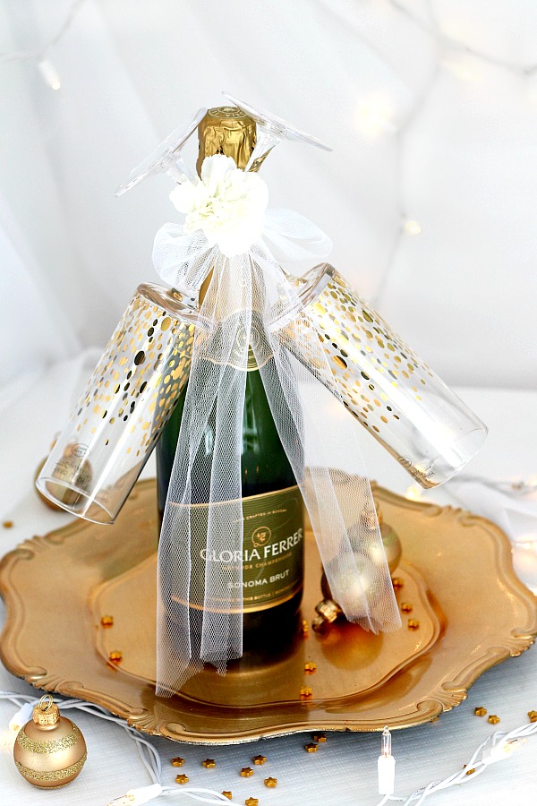 Easy DIY Champagne and flutes holiday gift makes a lovely friend or hostess gift. It takes just a few minutes and looks so festive. Ideal for welcoming the New Year or celebrating a birthday, anniversary, new job, new house or any special occasion.
