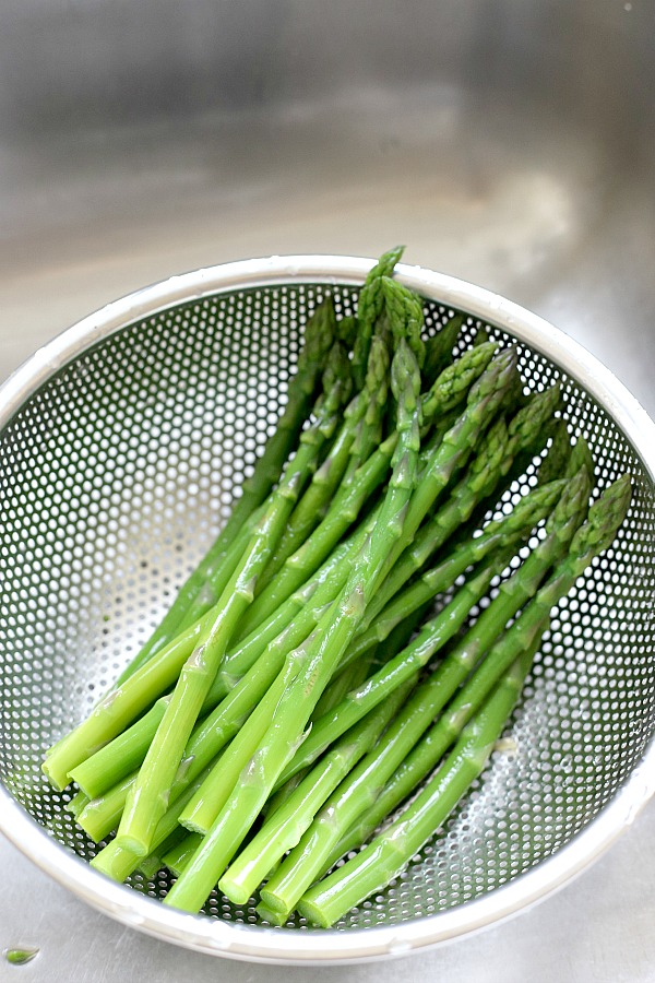 Fresh and delicious asparagus in a balsamic vinaigrette marinade is tender yet crunchy with a bright flavor from lemon zest. So easy to make with just a quick blanching. Pour on the salad dressing marinade and refrigerate until serving. A lovely Easter or brunch side dish.