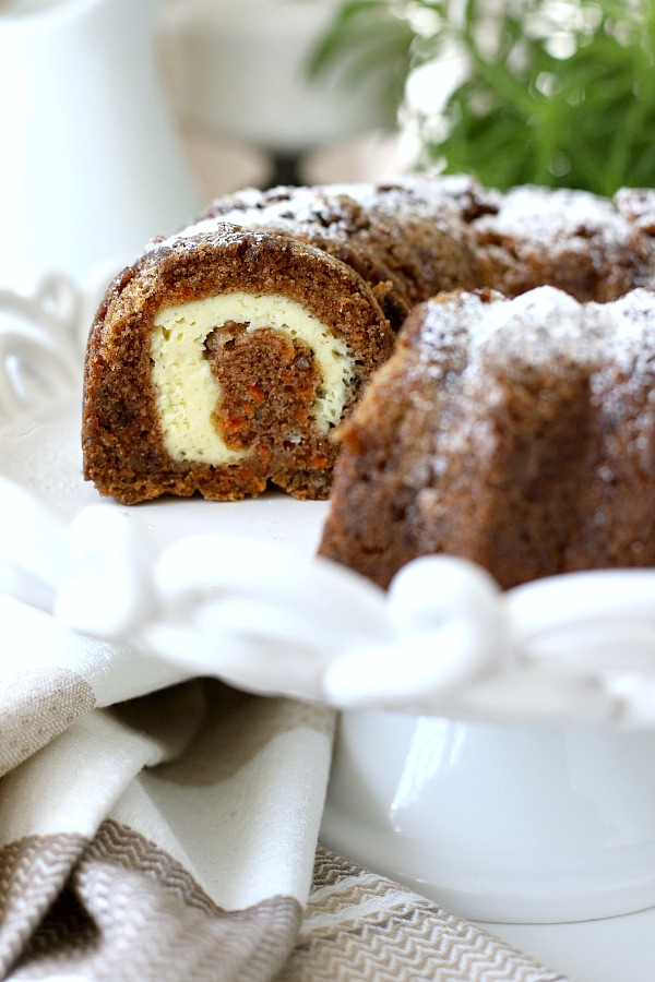 Filled with a tunnel of sweetened cream cheese, surprise carrot Bundt cake is a moist and delicious dessert. An easy recipe that needs only a dusting of sugar on top. A sweet addition to your Easter or brunch table.