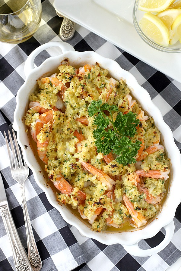Baked shrimp scampi is a super easy recipe! Arrange shrimp in a baking dish and top with a buttery herb mixture. Place in oven for a few minutes and enjoy a hot and bubbly, perfectly cooked dish elegant for your next dinner party or holiday meal.