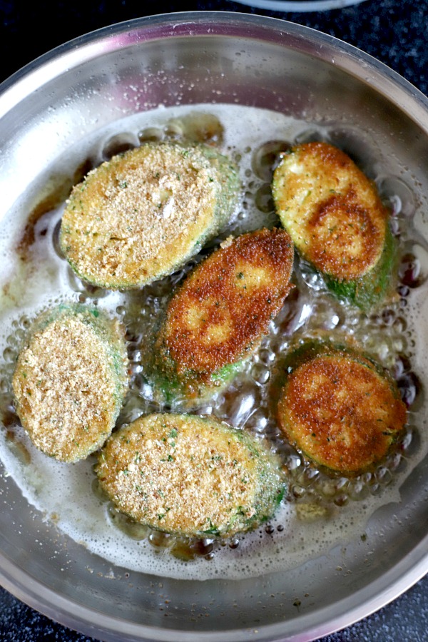 A summertime favorite, breaded fried zucchini is a great side or appetizer. Easy recipe using just a few ingredients and cooked in a skillet until golden brown and crispy.