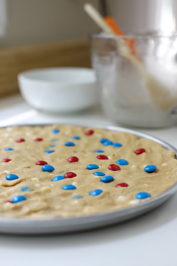 Celebrate the 4th of July with a giant patriotic peanut butter cookie pizza. Easy recipe the whole family will love.