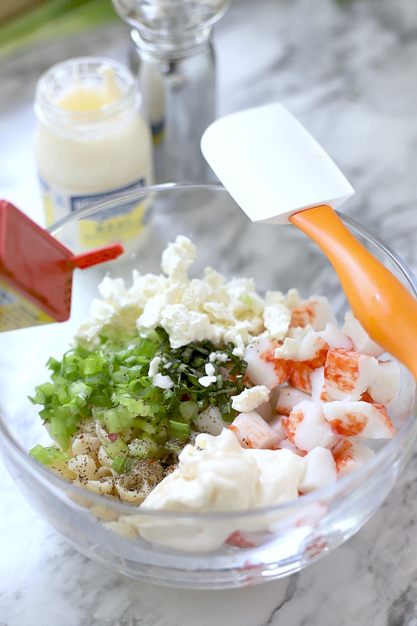 How to make pasta crab salad with veggies, basil, seasonings and fete cheese in a light dressing.