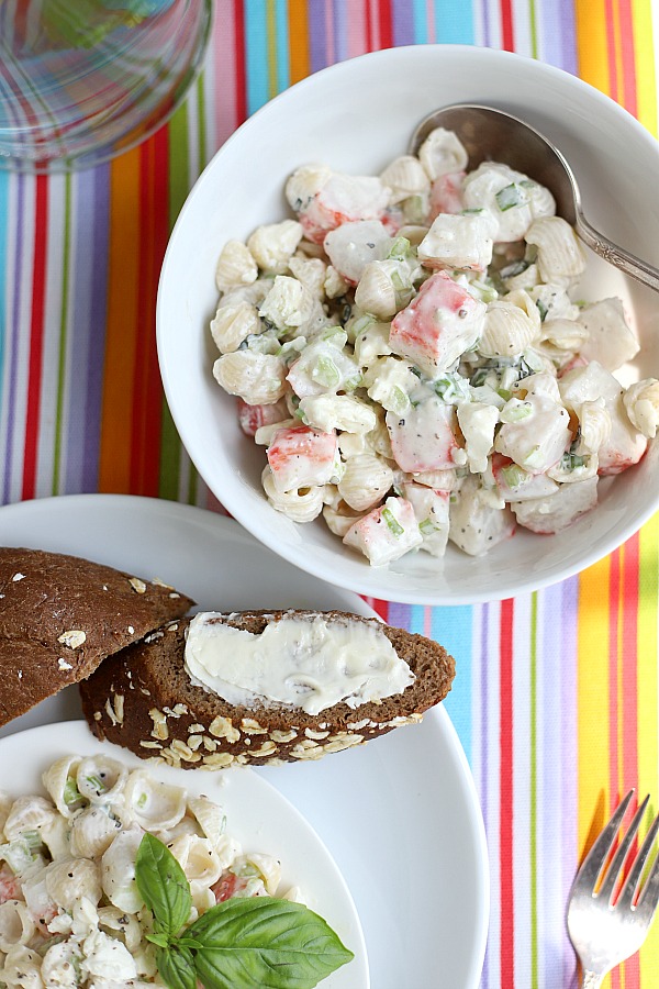 A light and satisfying lunch or dinner, pasta crab salad is a combo of imitation crab with chopped veggies, basil and feta cheese in light dressing. An easy, inexpensive seafood recipe.