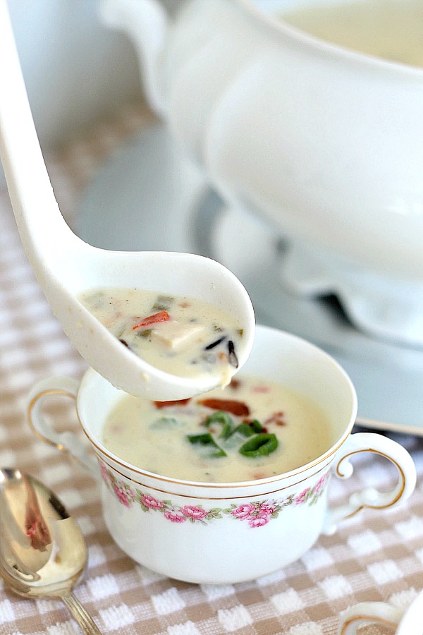 Enjoy a bowlful of creamy chicken wild rice soup with chicken chunks, rice, green onions and bacon! Easy recipe for a special company meal or yummy weeknight dinner.