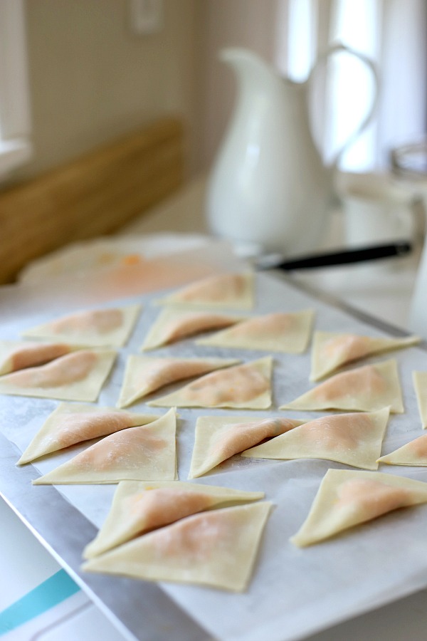 Sweet potato ravioli are pouches of filling in wonton wrappers, served with sage infused cream. An elegant vegetarian dinner entrée sure to please!