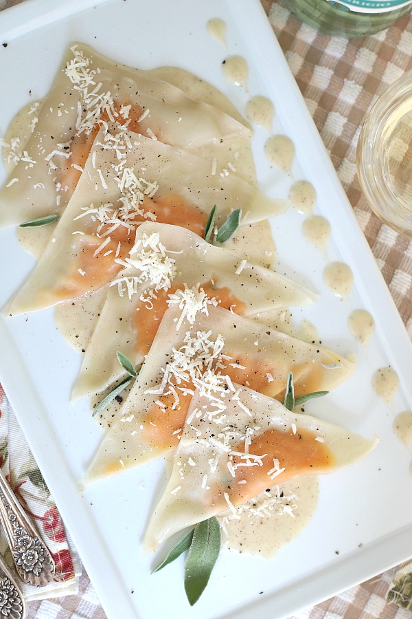 Delicate little pouches of sweet potato filling in wonton wrappers are served on a plate of cream infused with sage. Sweet potato ravioli is an elegant vegetarian dinner entrée sure to please!