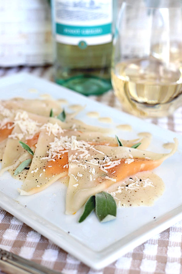 Sweet potato ravioli are delicious little pouches of sweet potato filling in wonton wrappers and served on a plate of cream infused with sage. A lovely vegetarian dinner entrée or for celebrating a special occasion and vegetarian friendly!