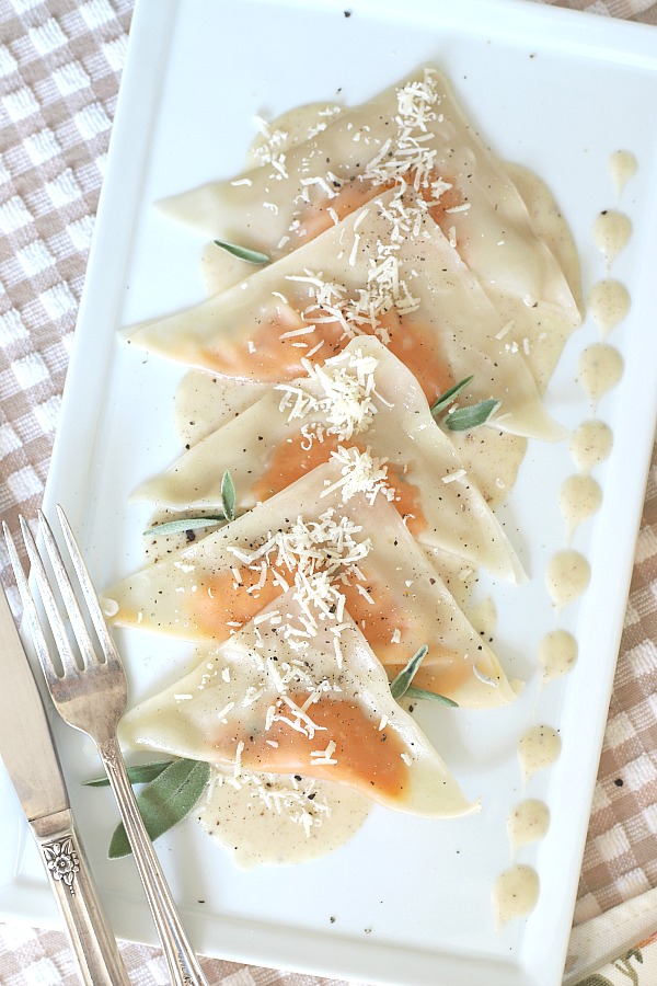 Sweet potato ravioli are prepared with a sweet potato mixture spooned onto wonton wrappers that are folded and simmered briefly in water until tender. Served on a plate with sage infused cream, they are a delicious vegetarian dinner entrée and just right for entertaining or a special occasion meal.
