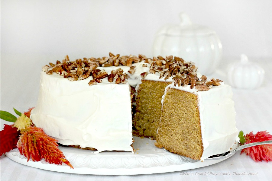 Pumpkin Pound Cake with Cream Cheese Frosting and topped with pecans.