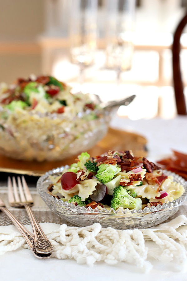 Broccoli grape pasta salad is a tasty and colorful side dish, lunch entrée or light dinner meal. Tender pasta is tossed with a creamy, sweet and tangy dressing and topped with toasted pecans and crisp bacon.