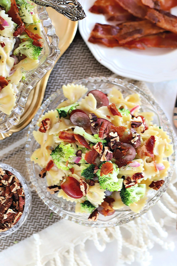 Easy recipe for Broccoli Grape Pasta Salad. Tender bow tie pasta with fresh broccoli, grapes in a sweet and tangy dressing topped with toasted pecans and crisp bacon. It is a perfect side dish, lunch or light dinner.