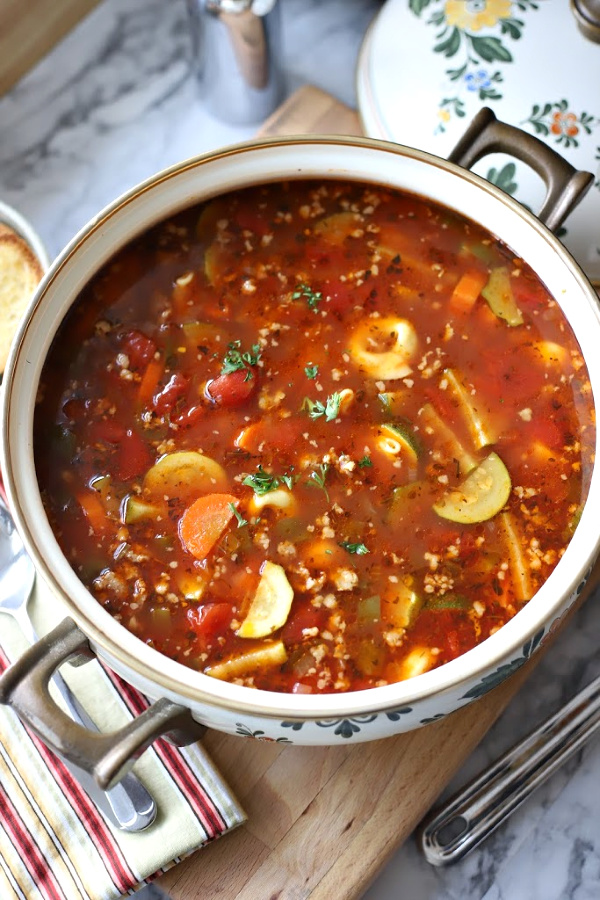 Easy recipe for robust and flavorful Italian sausage soup is a meal in a bowl. Tender vegetables with sausage and tortellini in a tomato broth will warm you soul and tummy.