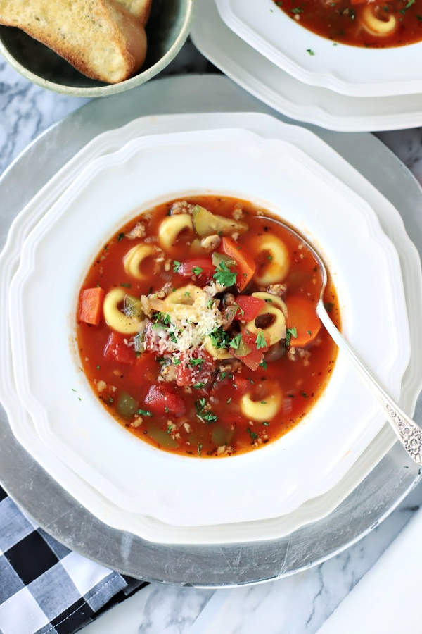 Easy recipe for robust and flavorful Italian sausage soup is a meal in a bowl. Tender vegetables with sausage and tortellini in a tomato broth is special for entertaining or perfect for weeknight dinner with crusty bread. 