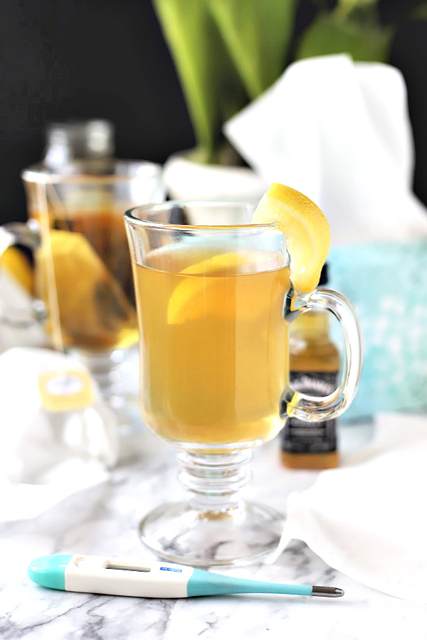 Feel better from cold and flu symptoms with a warm and tasty hot toddy beverage made with bourbon whiskey, tea, honey and lemon, like grandmom used to make. 
