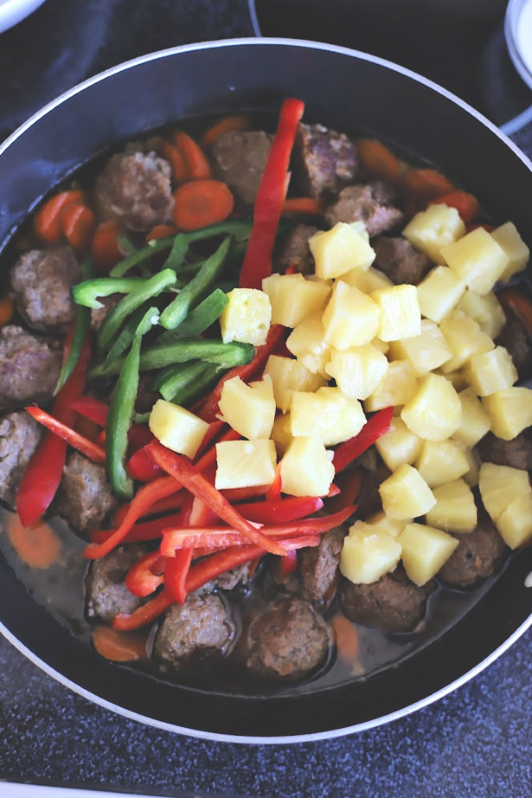 Easy recipe for Sweet and sour meatballs. Bell peppers and carrots are cooked crisp tender and added with pineapple chunks to a lightly tangy sauce. Serve over rice for a great weeknight or family dinner.