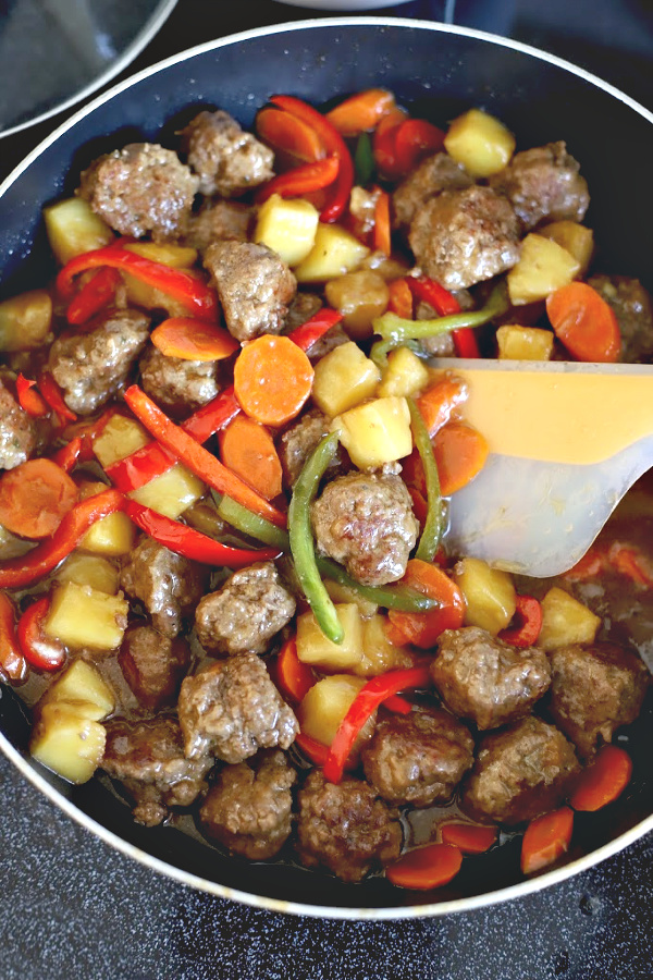 Easy recipe for Sweet and sour meatballs. Bell peppers and carrots are cooked crisp tender and added with pineapple chunks to a lightly tangy sauce. Serve over rice for a great weeknight or family dinner.