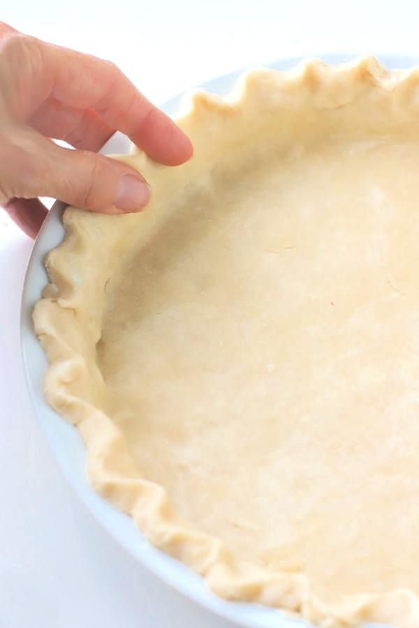 Making you own homemade pie crust is a lot easier than you think and much less expensive.  Easy step-by-step photos for a perfect crust using shortening for your apple, pumpkin and savory pies.