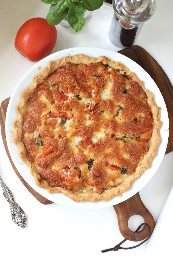 Enjoy the bright flavor combo of fresh tomatoes and basil. Easy recipe for basil tomato pie combines creamy cheese in a flaky pastry crust. Basil tomato pie is savory and delicious!