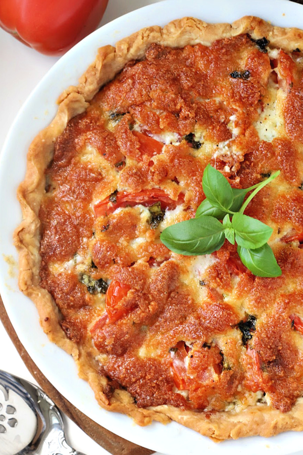 There is something about the flavor combo of fresh tomatoes and basil. Combined with creamy cheese in a flaky crust, basil tomato pie is bright, savory and delicious!