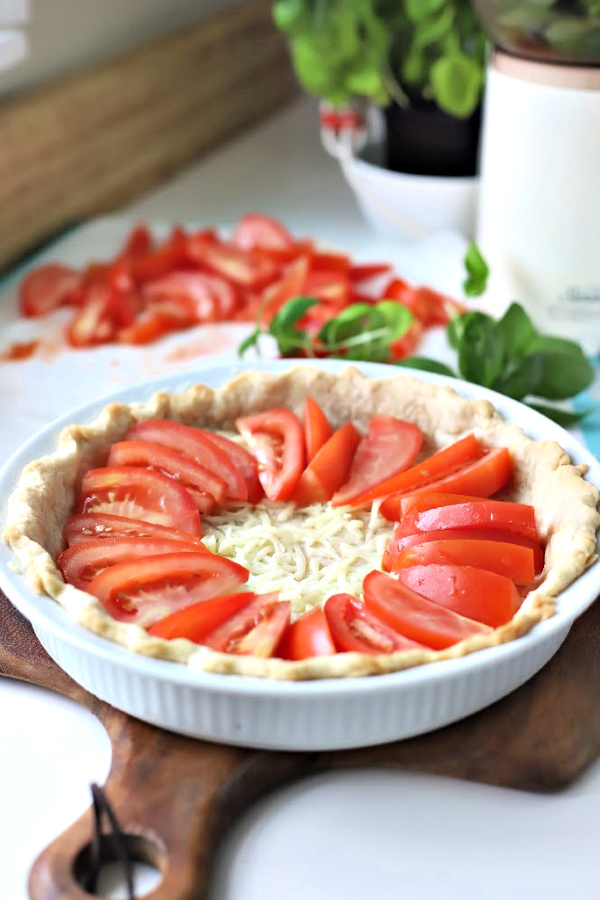 There is something about the flavor combo of fresh tomatoes and basil. An easy recipe that combines creamy Mozzarella and Parmesan cheese in a flaky crust. Basil tomato pie is bright, savory and delicious! Serve as an appetizer or entrée.