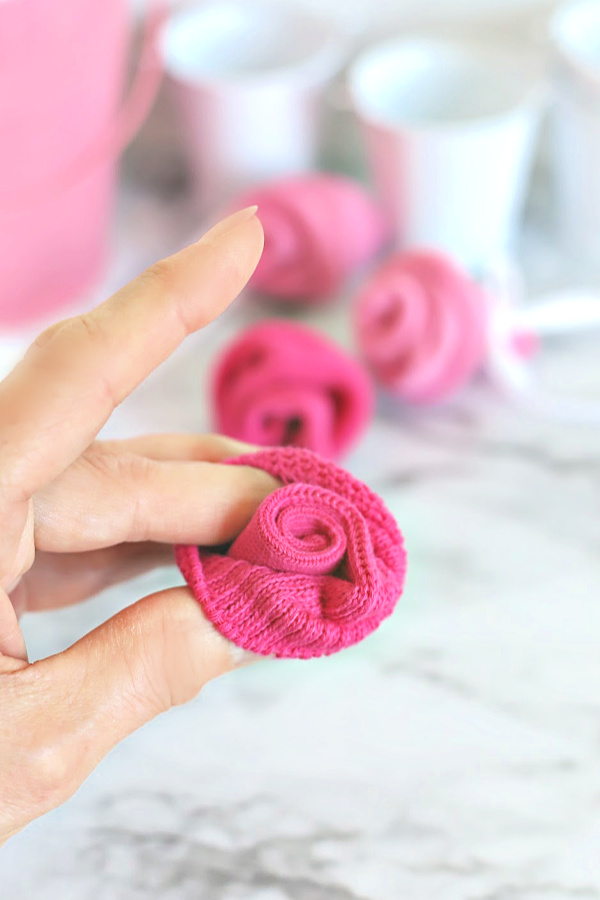 Easy step-by-step how-to for bud roses from baby socks. DIY flowers for shower corsage and décor ideas.