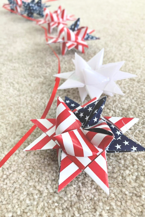Easy step-by-step video tutorial how-to for patriotic paper stars perfect for 4th of July, Memorial Day or the military hero in your life. Made by folding and turning strips of paper creating a lovely 16-pointed, three dimensional ornament.