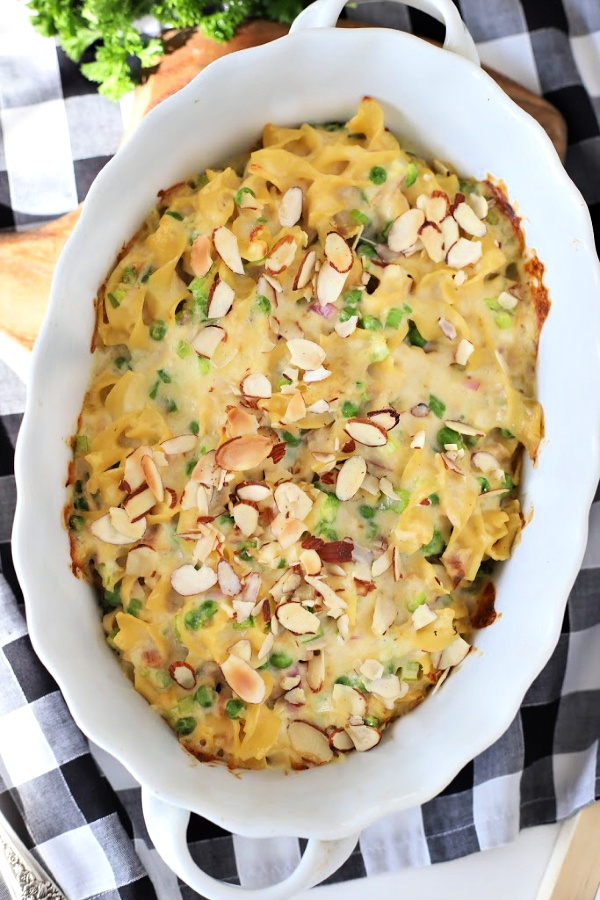 There is just something about the humble tuna noodle casserole. This old-fashioned classic is both budget-friendly and a yummy comfort food.  Easy to make too. A timeless recipe with creamy, cheesy, tender noodles that comes out of the oven in just 20 minute