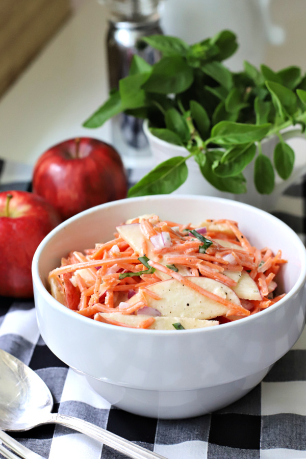 An easy recipe for a fresh and healthy salad or side dish, apple carrot slaw is colorful, crunchy and flavorful with the brightness of basil.