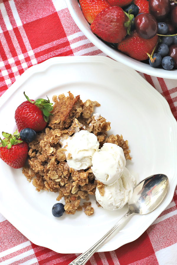 serving homemade baked oatmeal with vanilla ice cream with berries for dessert