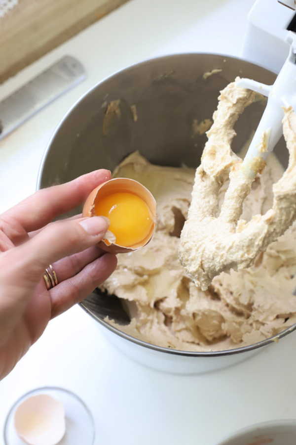 adding egg to chocolate peanut butter cookie batter