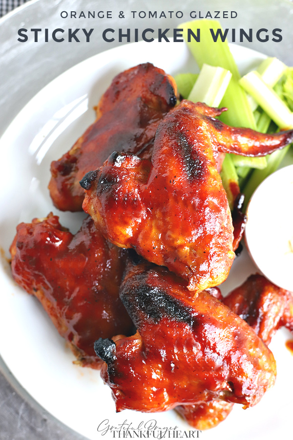 Slow roasted sticky chicken wings with and orange tomato glaze are baked until tender and the glaze is thick. Serve as an appetizer or entrée.