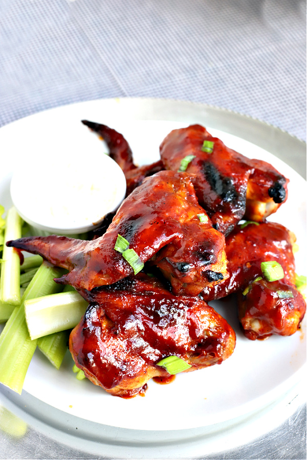Slow roasted sticky chicken wings with and orange tomato glaze are baked until tender and the glaze is thick. Make them as spicy as you like. Serve as an appetizer or entrée.
