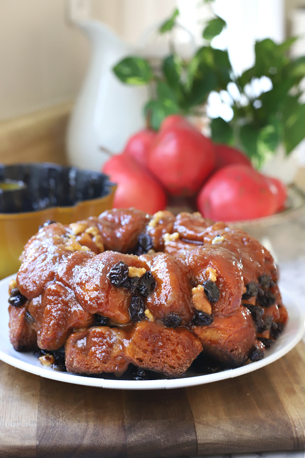Easy recipe for homemade warm, gooey monkey bread with cinnamon. Dough from refrigerator biscuits for soft pull-apart breakfast or dessert.