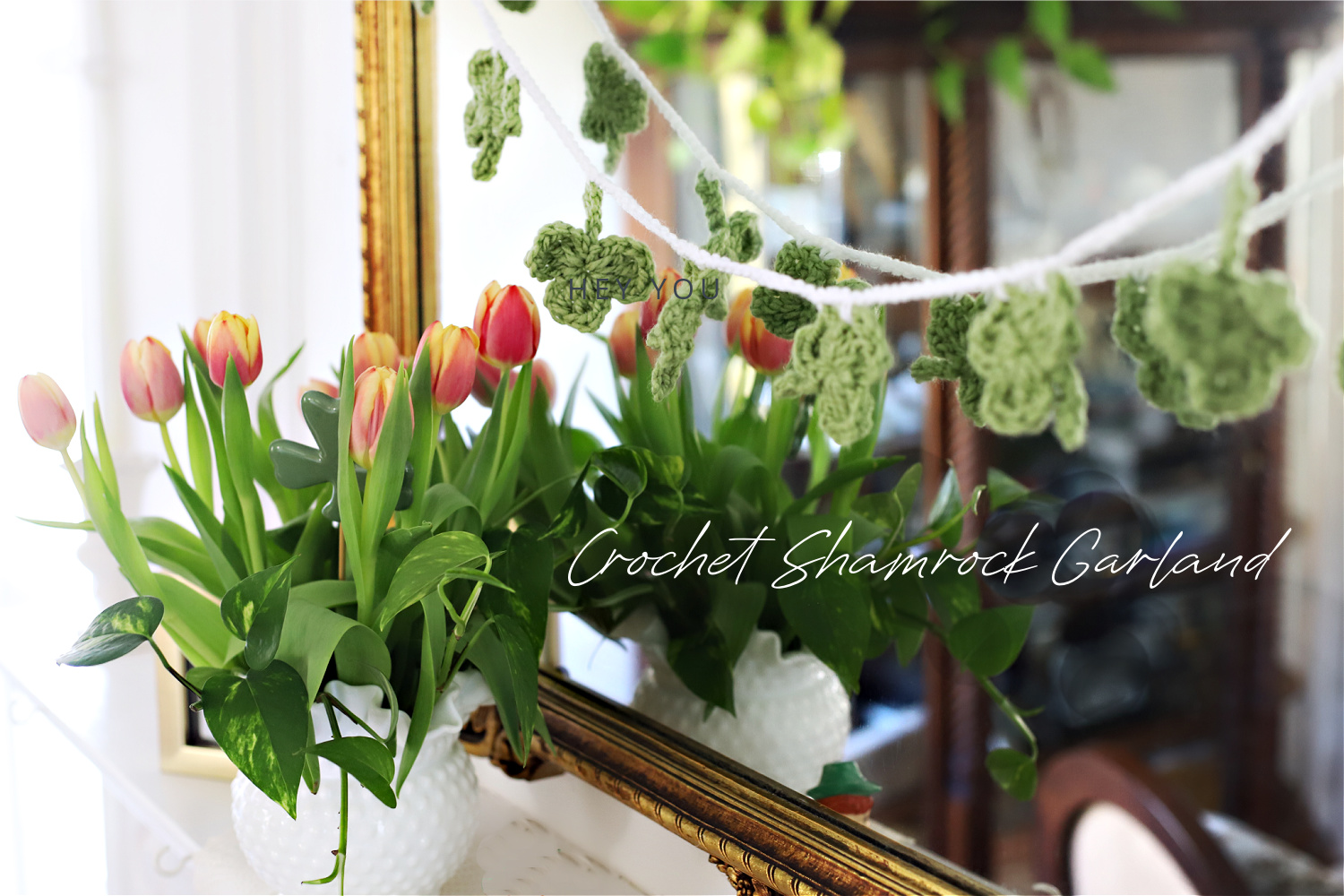 Crochet shamrock garland for S Patrick's Day swaged over mantle mirror