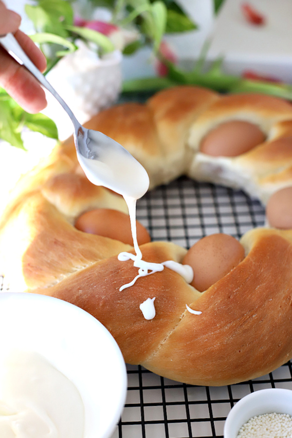 drizzling frosting onto a baked Easter Bread