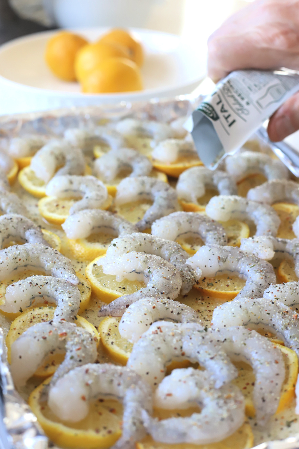 Adding Italian Seasoning Mix for one pan lemon shrimp recipe.
