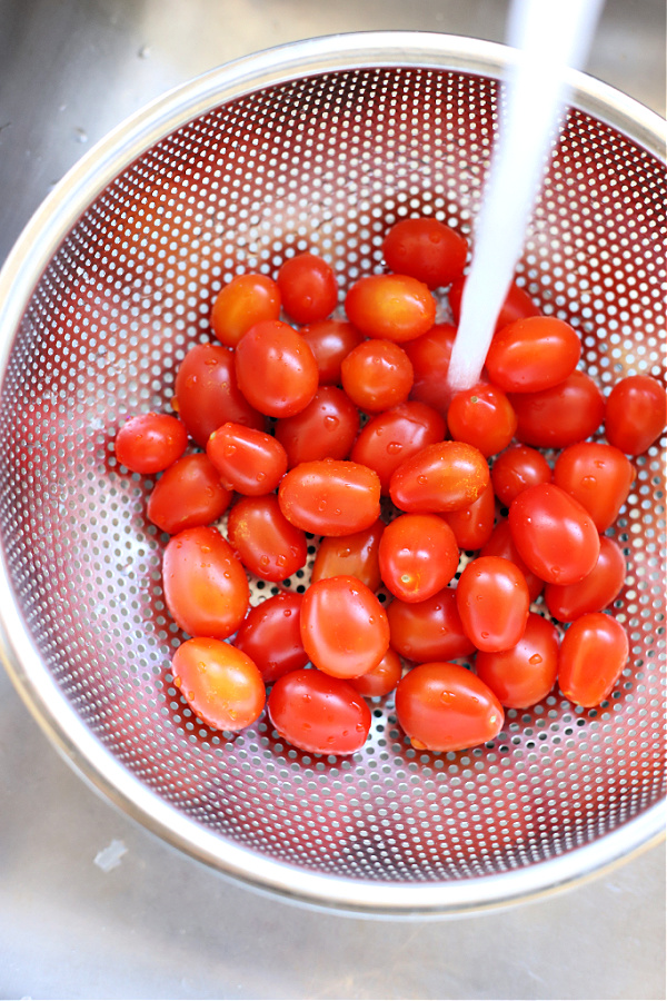 rinsing cherry tomatoes for feta pasta