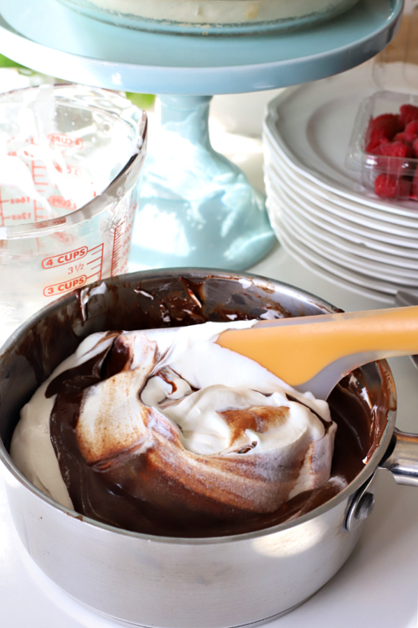 folding fresh whipped cream into melted chocolate for chocolate cream pie recipe