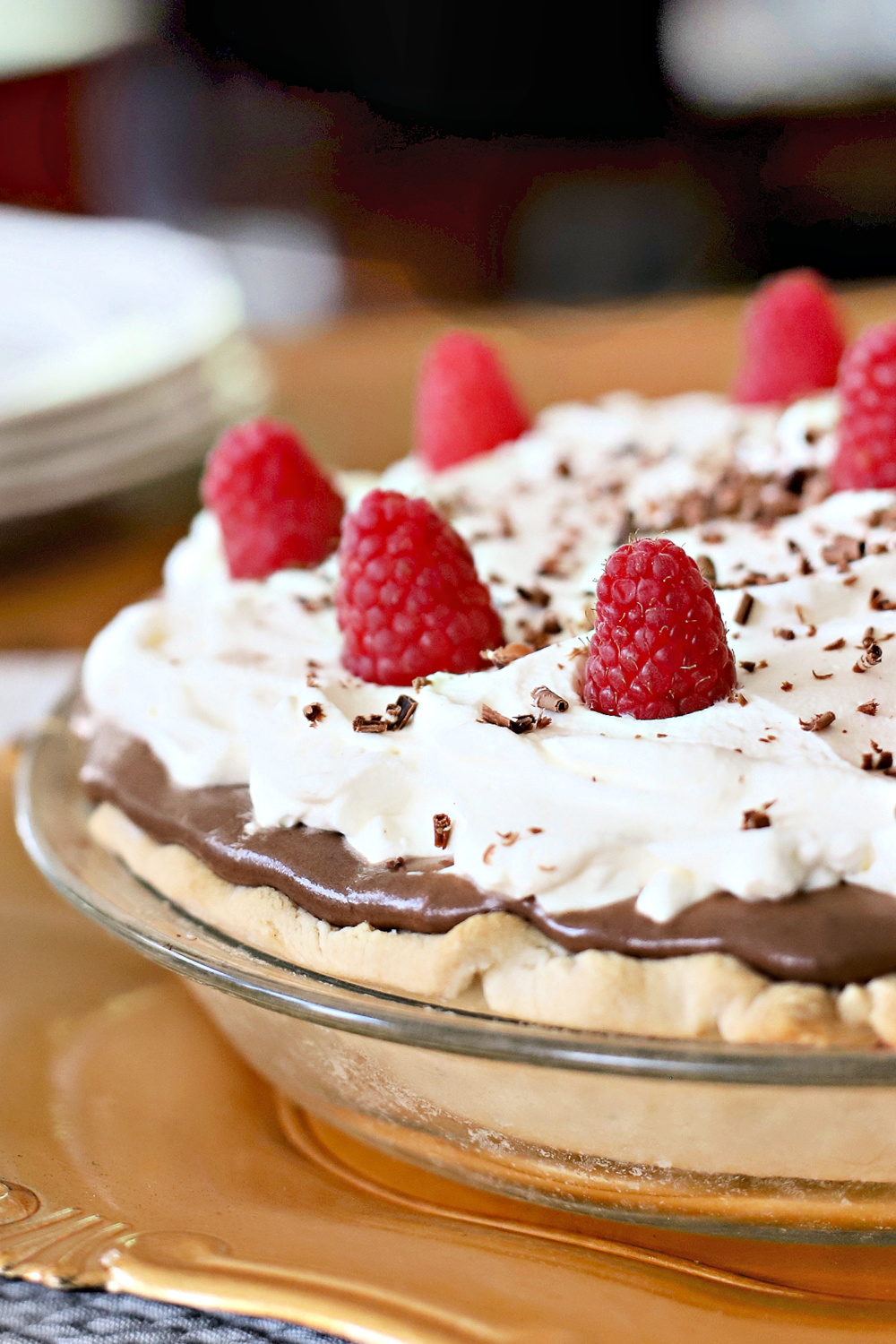 Easy recipe for a creamy, decadent chocolate cream pie with cream cheese and dark chocolate chips using a homemade or refrigerator pie crust. 