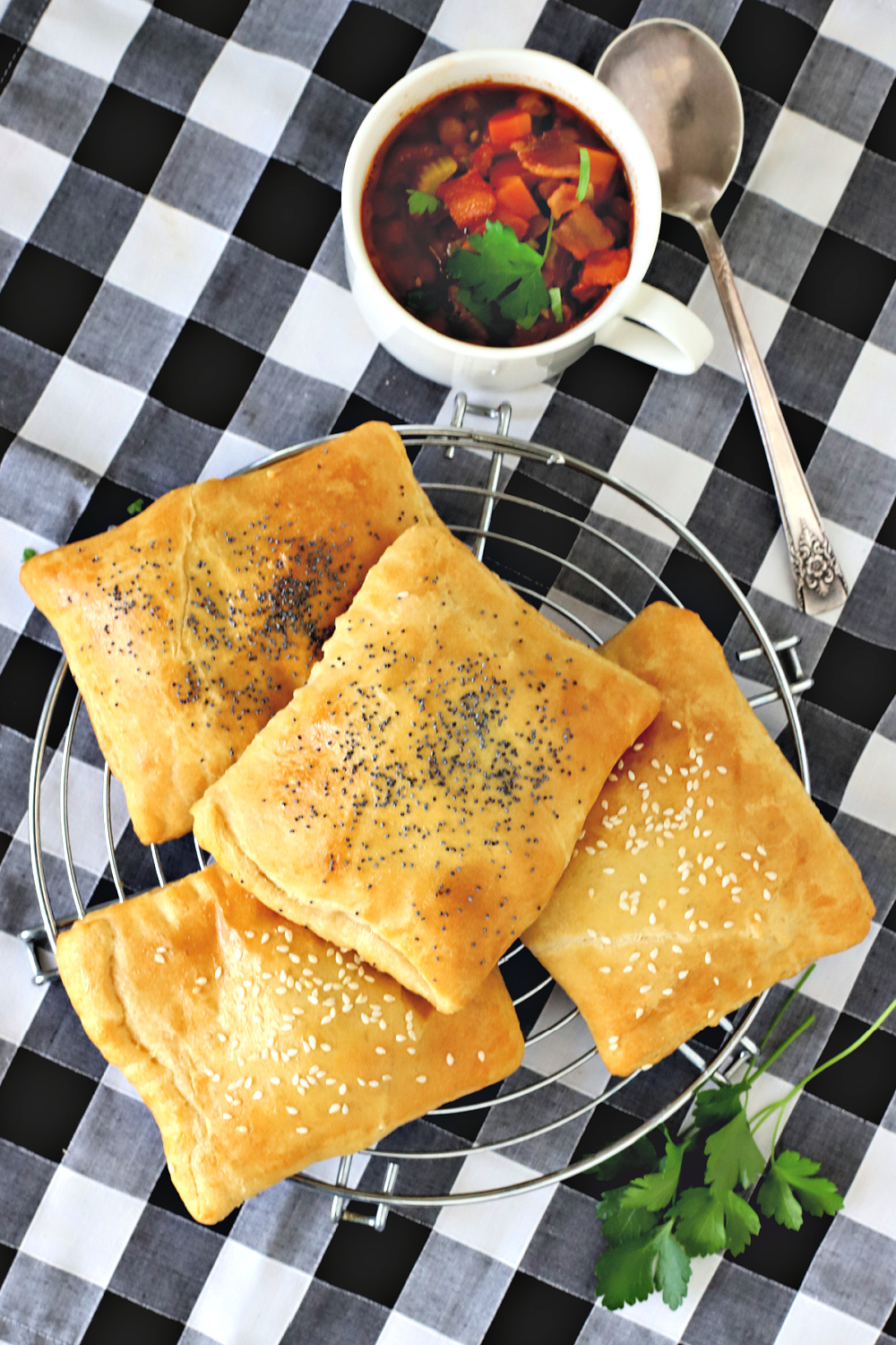 Easy recipe for ham & cheese hand pies are a quick and easy lunch or dinner hot sandwich. Fill crescent roll dough with Swiss, cheddar or American cheese, sprinkle with poppy or sesame seeds, if desired and bake!