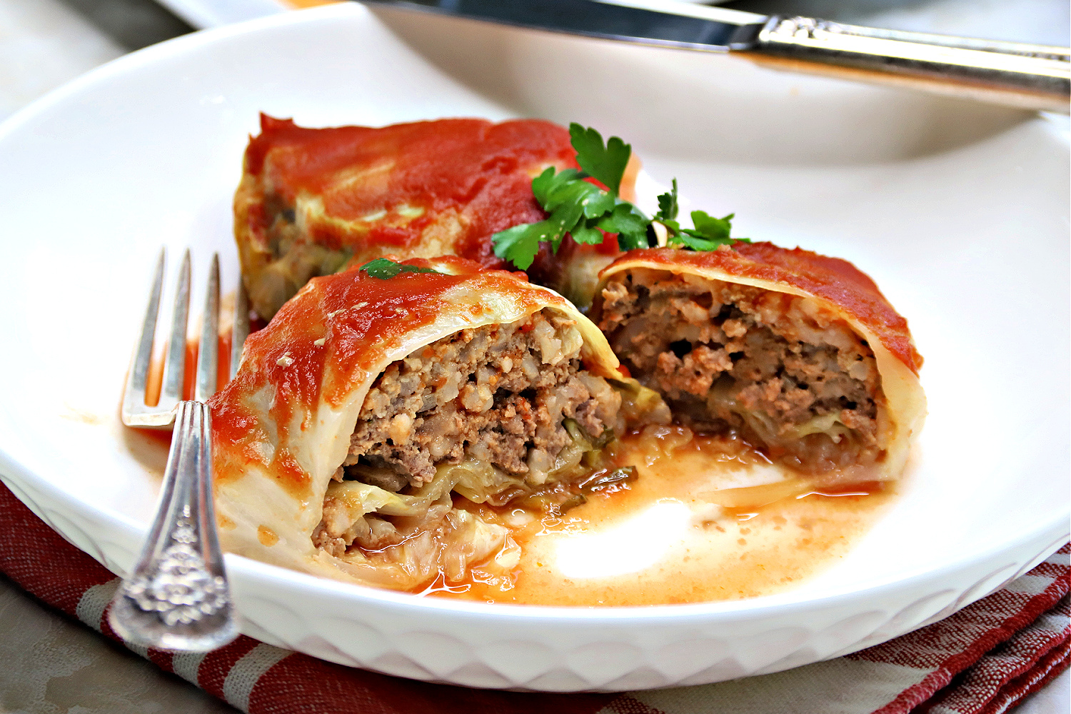 Easy slow cooker recipe for Swedish cabbage rolls filled with ground beef and rice in a tasty sauce is a comforting and satisfying dinner meal.