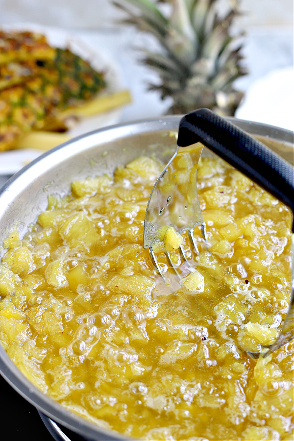 mashing fruit for Pineapple jam